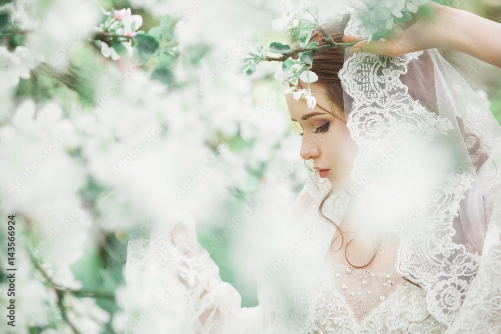 Beauty girl in the lush garden of apple trees . Beauty girl in the lush garden of apple trees .