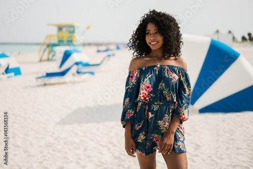 Fashion woman walking on beach with a summer dress