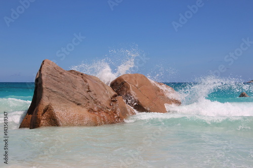 Red Granite Rock, Wave Breaking / Beach Anse Lazio, Praslin Island, Seychelles, Indian Ocean, Africa / The beautiful white sandy beach is bordered by large red granite rocks. 