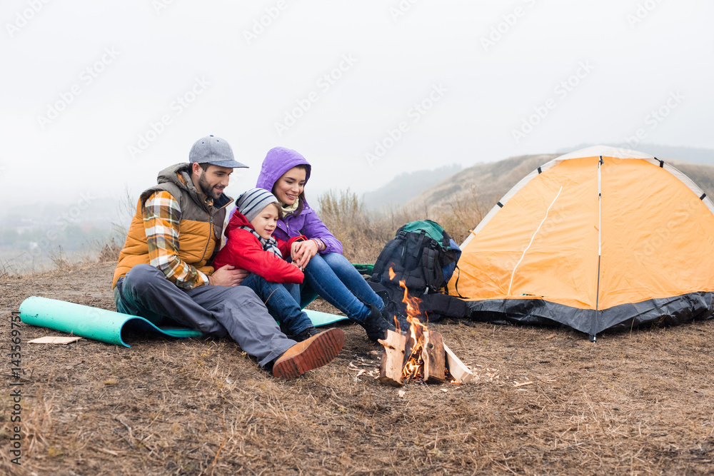 Happy family looking at burning fire