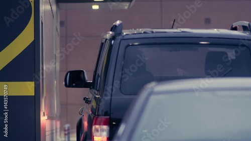 Man's hand paying in cash in auto fast food