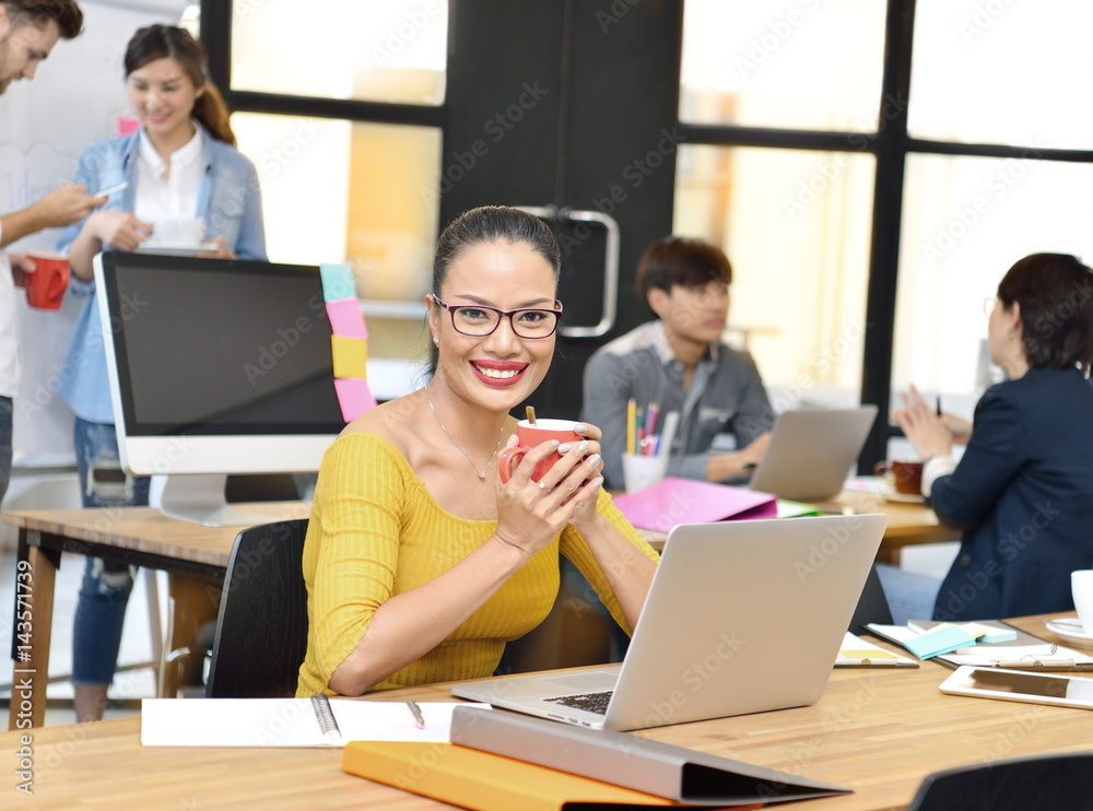 Senior businesswoman smiling at camera in office environment Senior businesswoman smiling at camera in office environment
