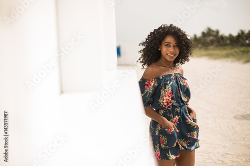 Fashion woman walking on beach with a summer dress