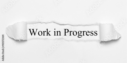 Vászonkép Work in Progress on white torn paper