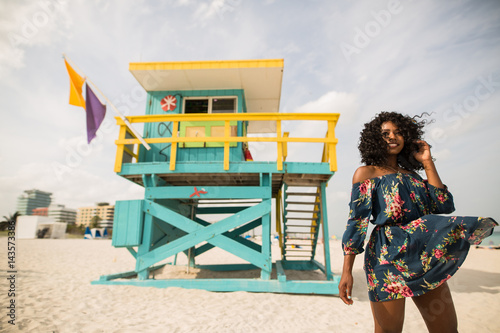 Fashion woman walking on beach with a summer dress