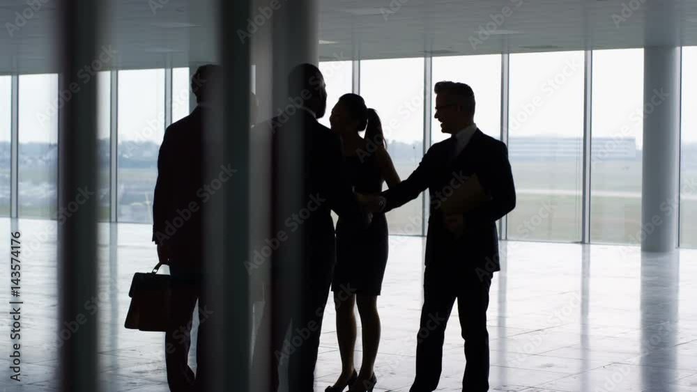  Business team viewing empty commercial property & shaking hands with agents