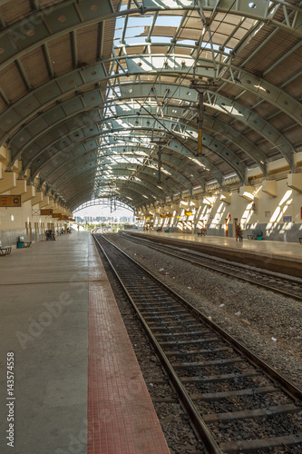 Fototapeta Naklejka Na Ścianę i Meble -  Narrow view of a locomotive electric train station platform with covered tunnel, Chennai, India, Mar 29 2017