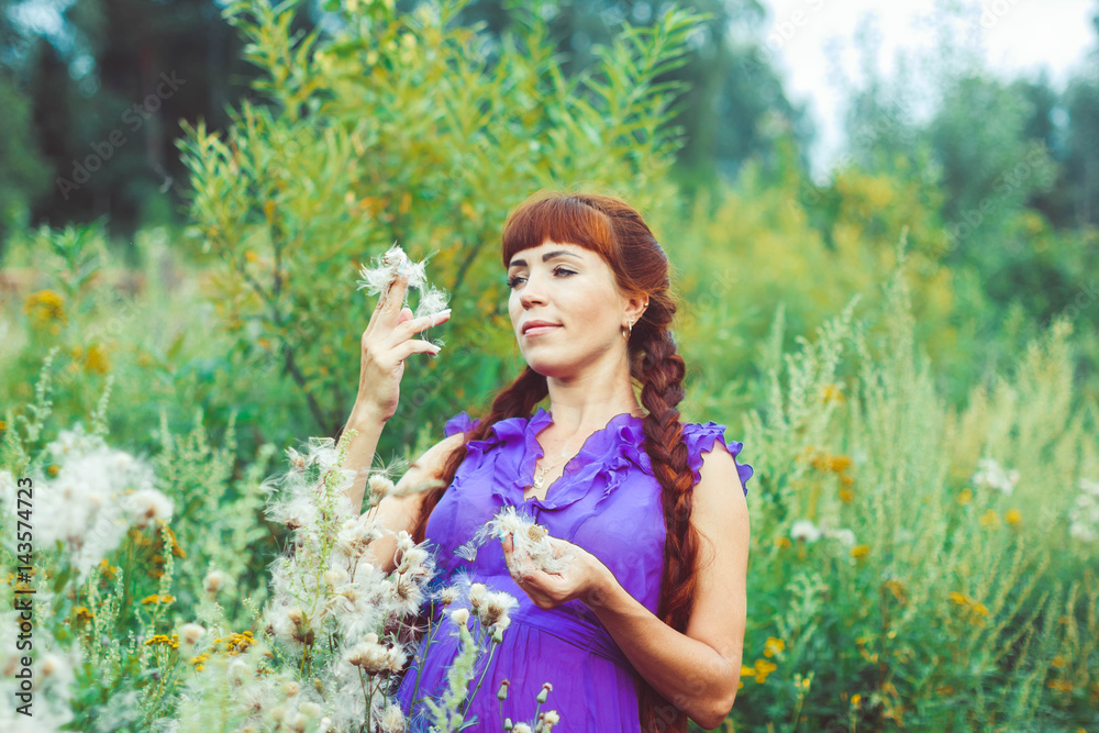 woman in dress in field of dandelions woman in dress in field of dandelions