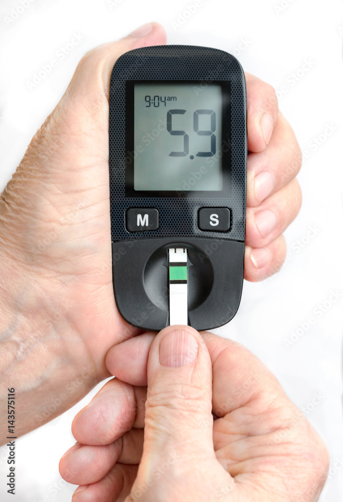 An elderly woman holds a glucometer in her hands and wants to do a blood test for sugar An elderly woman holds a glucometer in her hands and wants to do a blood test for sugar