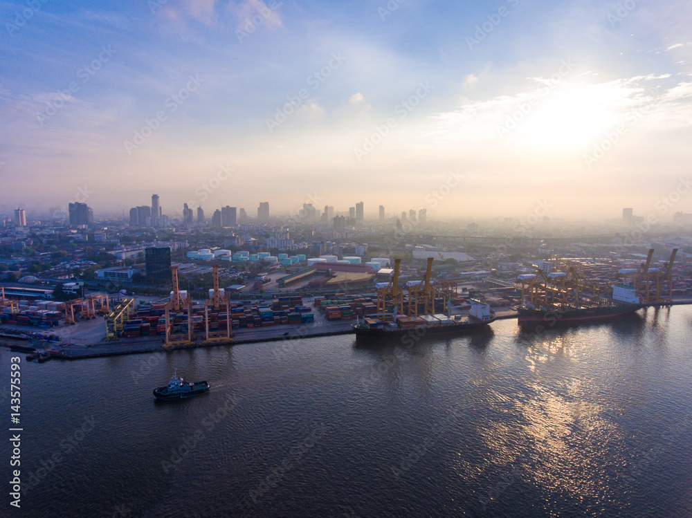 Fototapeta premium Aerial shot of container ship in dock with beautiful sunlight in the morning