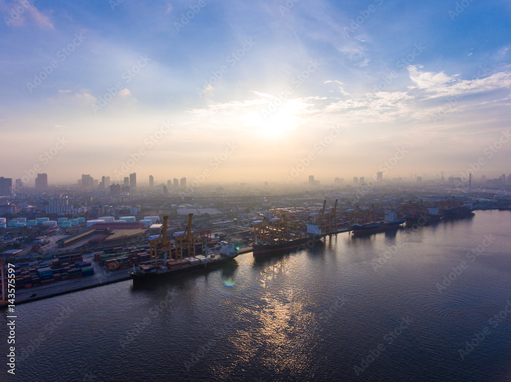 Aerial shot of container ship in dock with beautiful sunlight in the morning