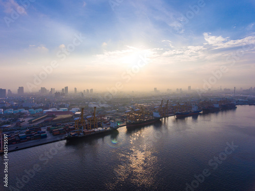 Aerial shot of container ship in dock with beautiful sunlight in the morning