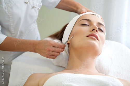 Find Similar  Get a Comp  Save to LightboxSpa salon  young beautiful woman having facial treatment.