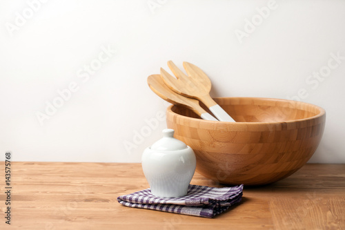 Wooden bowl and cutlery with an Espresso maker on wooden background or table. Natural serving table setting