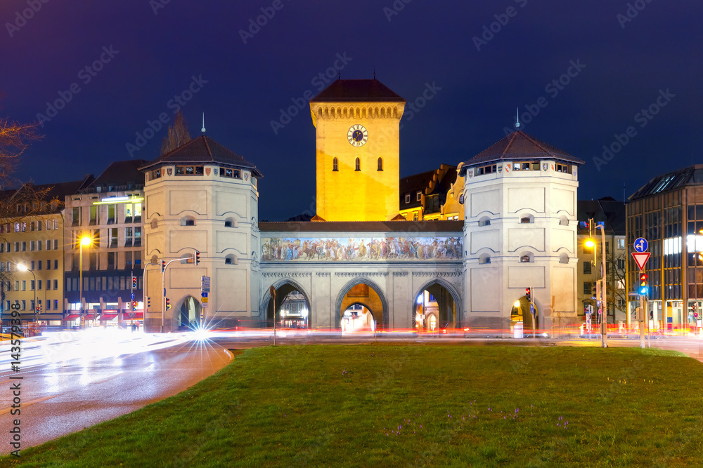 The Isartor gate, one of four main gates of the medieval city wall at night, Munich, Germany