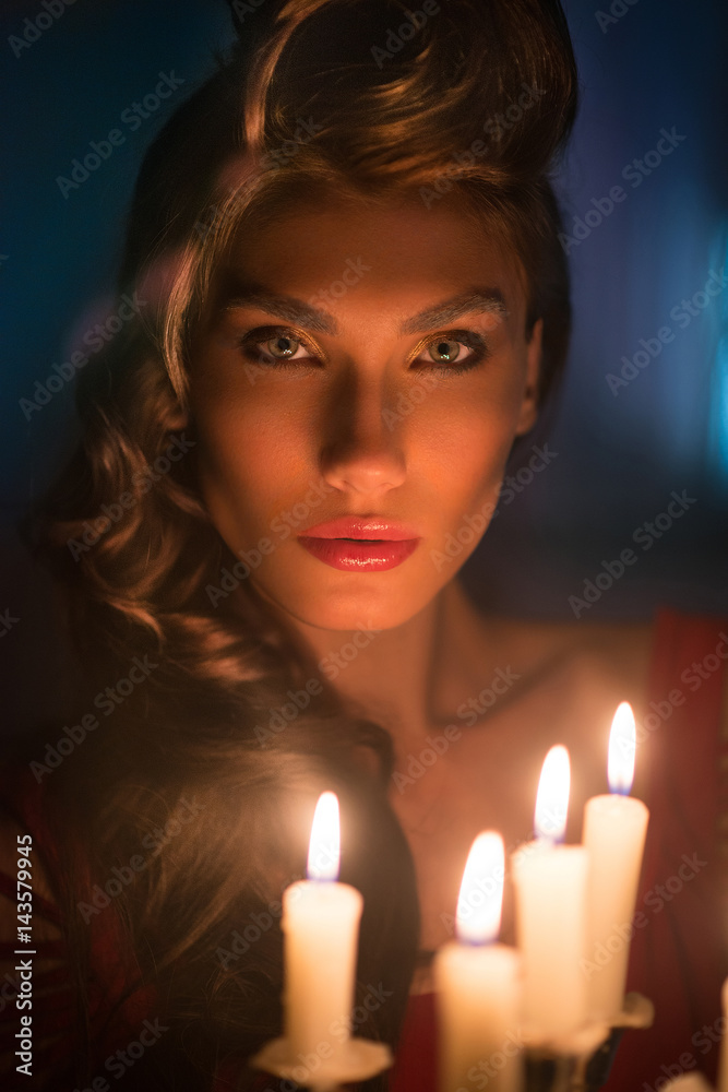 Beautiful woman in the dark room with a lot of candles Beautiful woman in the dark room with a lot of candles