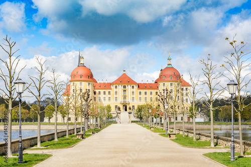 Moritzburg Castle in the spring. This famous water castle with beautiful gardens and access road became famous by Czech-German fairytale Cinderella.