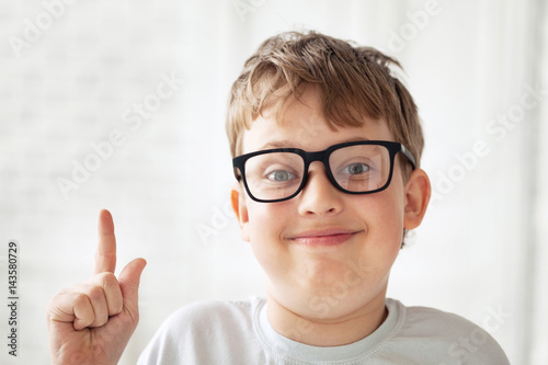 clever teen boy in glasses indoors