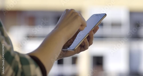 Close-Up Woman Using Smartphone On The Balcony