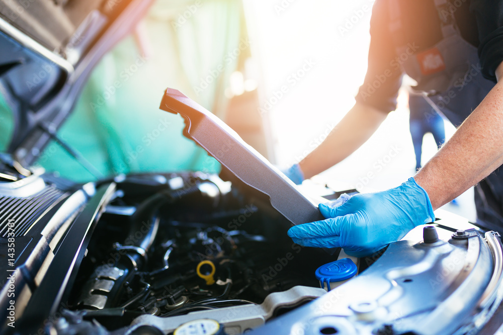 Auto mechanic repairing car. Selective focus. Auto mechanic repairing car. Selective focus.