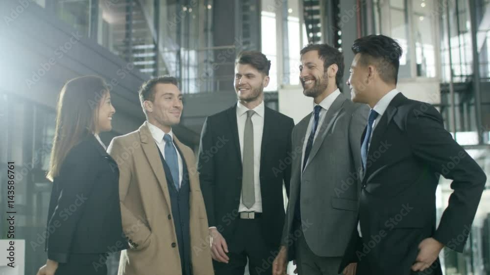 Portrait smiling diverse business group in large modern office building Portrait smiling diverse business group in large modern office building