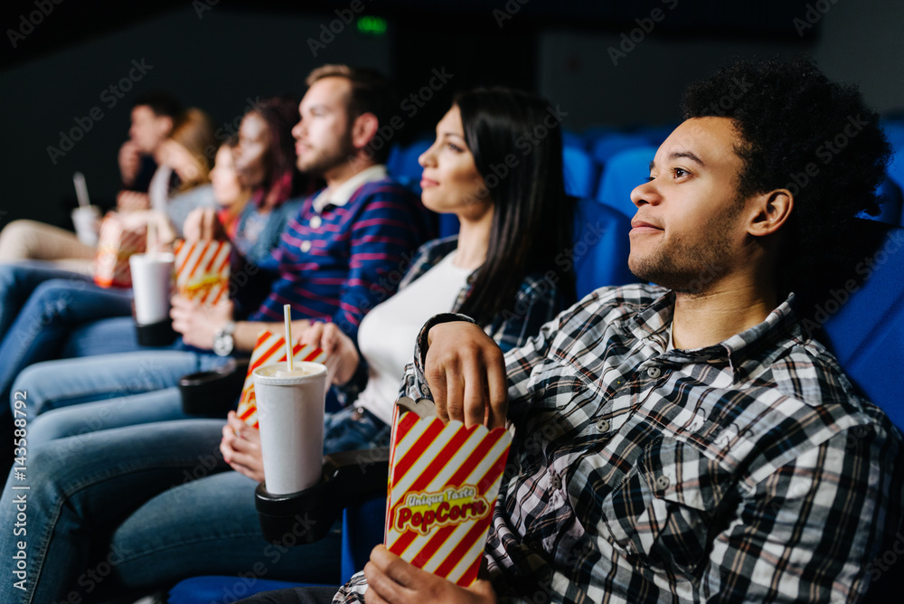 Mixed race group of people watching a movie