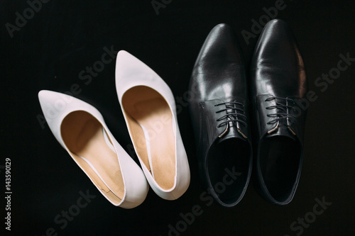Shoes of the bride and groom. Lying or standing next to each other. Wedding accessories bride and groom.