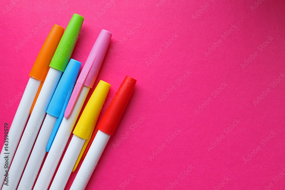 colorful pens on Pink background colorful pens on Pink background