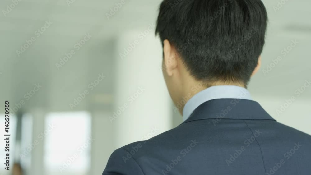  Business teams meet & shake hands in large modern office building