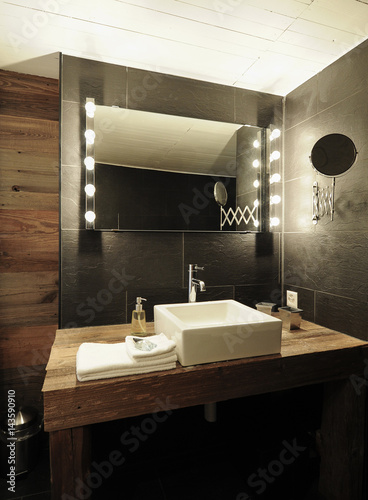 Wood and white designer bathroom in an old renovated chalet