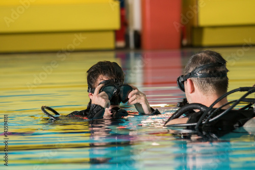 scuba diving course pool teenager girl with instructor 