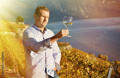 Man holding a glass of wine. Lavaux, Switzerland © HappyAlex