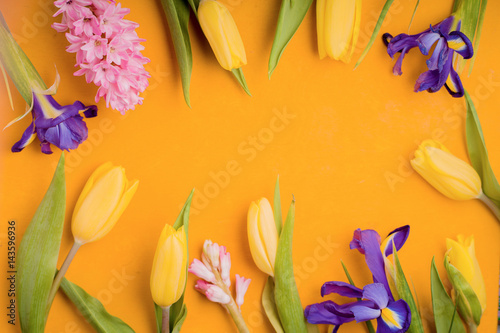 Frame of flowers on a yellow background photo