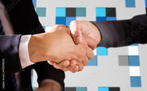 Composite image of male and female corporates shaking hands photo