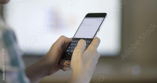 Close up of woman hands texting, sending sms on smartphone, slow motion