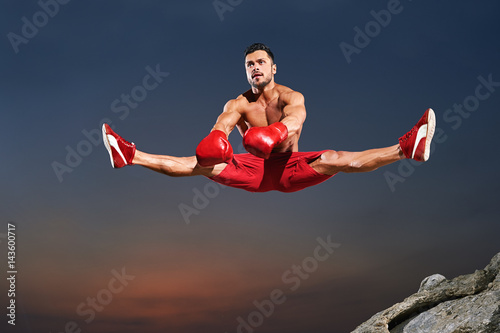 Horizontal shot of a young handsome muscular sportsman doing splits in the air jumping high copyspace gymnast physique sport athletics active lifestyle flexibility stretch fitness motivation endurance