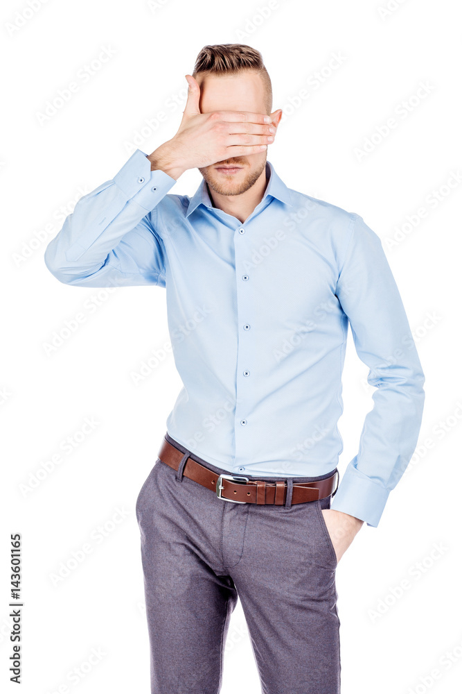 portrait young businessman covering his eyes with his hand. emotions, facial expressions, feelings, body language, signs. image on a white studio background. portrait young businessman covering his eyes with his hand. emotions, facial expressions, feelings, body language, signs. image on a white studio background.
