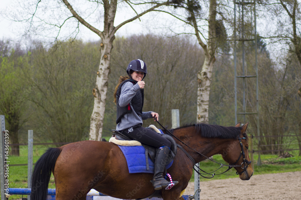 cross county horse jumping over bars by teenager girl
cross county horse jumping over bars by teenager girl