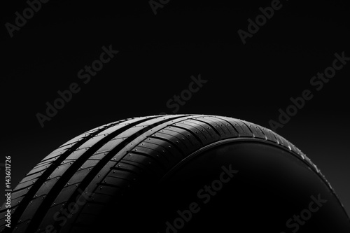 Car tire on black background photo
