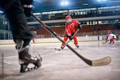 Hockey match at rink player in action .