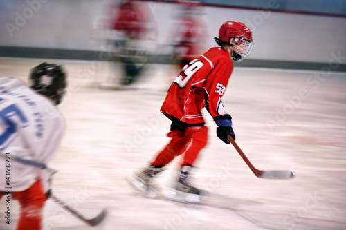 boy playing ice hockey on the rink.