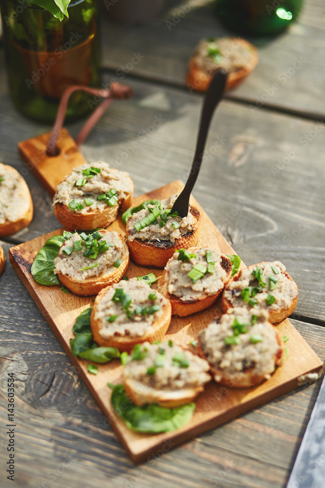 crispy open-face sandwiches with mutabal topping on the cutting board crispy open-face sandwiches with mutabal topping on the cutting board