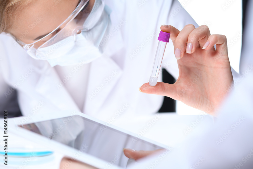 Scientific research team with clear solution in laboratory, close up Scientific research team with clear solution in laboratory, close up