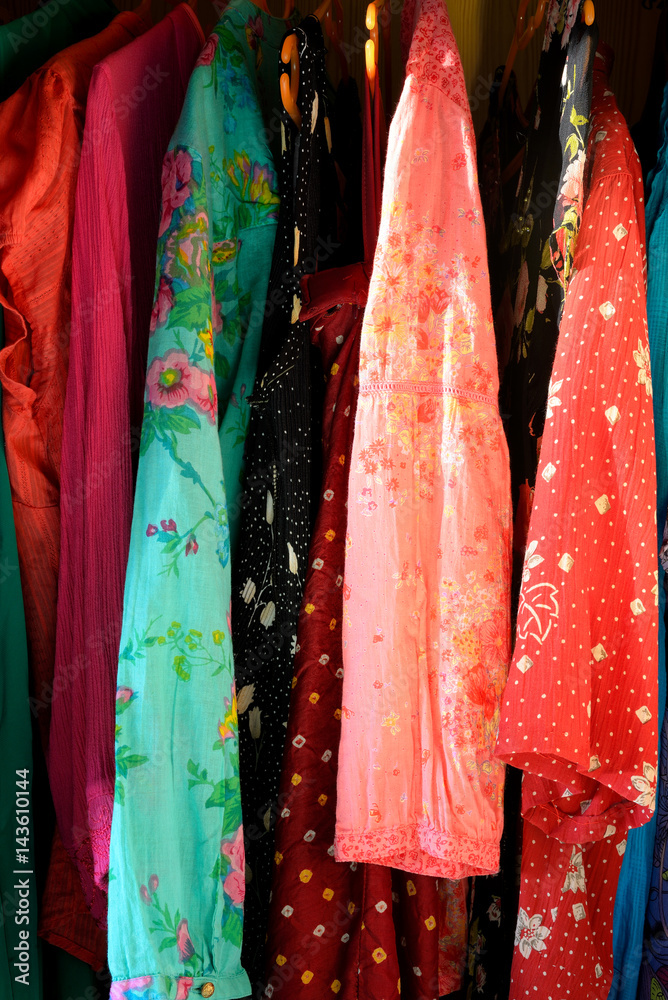Summer outfits hanging in a closet