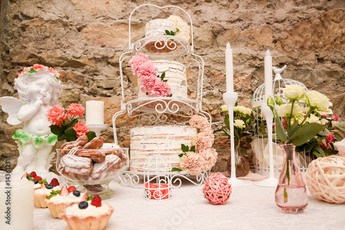 Luxurious wedding cake with candy bar. Cupcake, photo