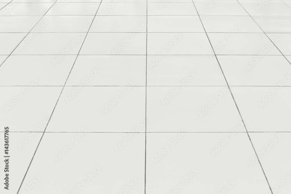 White tile floor background in perspective view. Clean, shiny, symmetry with grid line texture. For decoration in bathroom, kitchen and laundry room. And empty or copy space for product display also. White tile floor background in perspective view. Clean, shiny, symmetry with grid line texture. For decoration in bathroom, kitchen and laundry room. And empty or copy space for product display also.