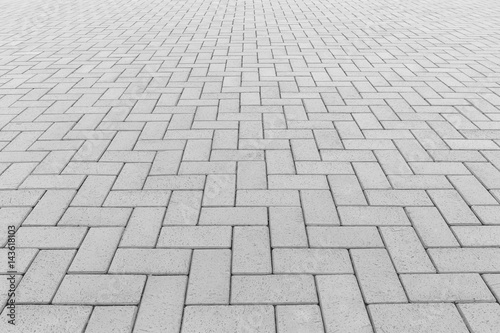 Paver brick floor also call brick paving, paving stone or block paving. Manufactured from concrete or stone for road, path, driveway and patio. Empty floor in perspective view for texture background. photo