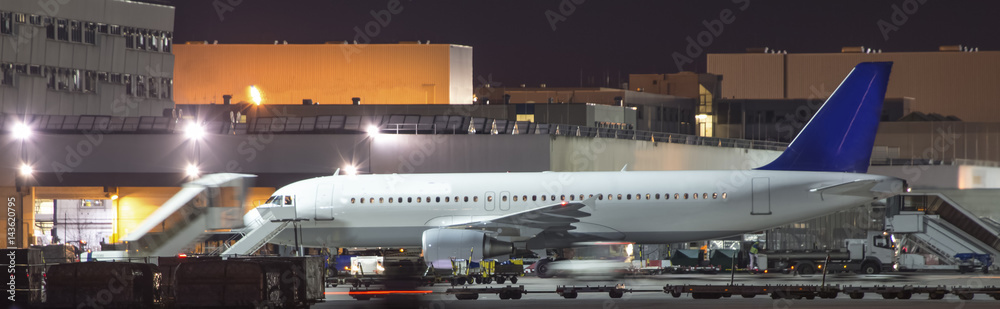 airplanes boarding at an airport at night