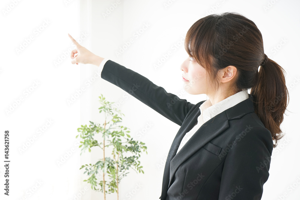 Young business woman pointing something with smile Young business woman pointing something with smile