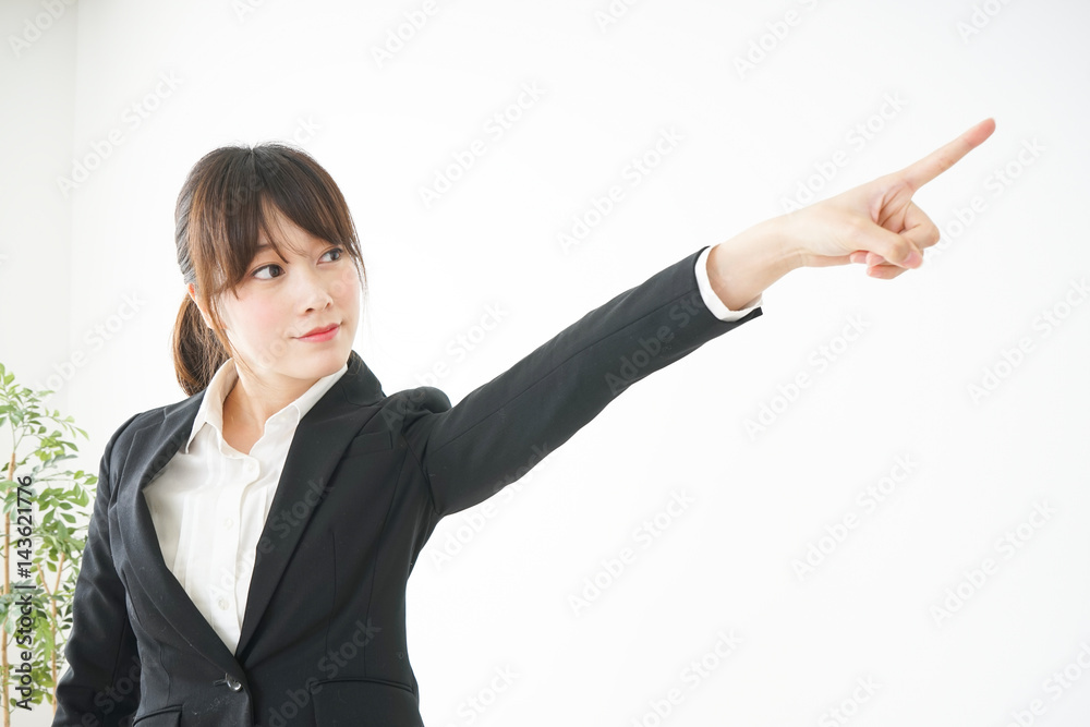 Young business woman pointing something with smile Young business woman pointing something with smile